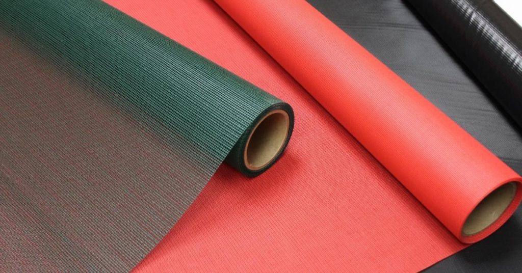 Snyder Manufacturing coated mesh fabrics in red, green and black rolls