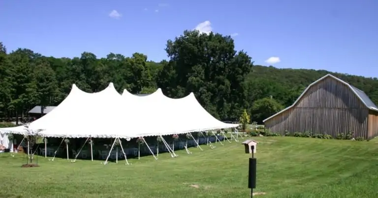 White party tent in a yard made with Snyder Manufacturing tent fabric